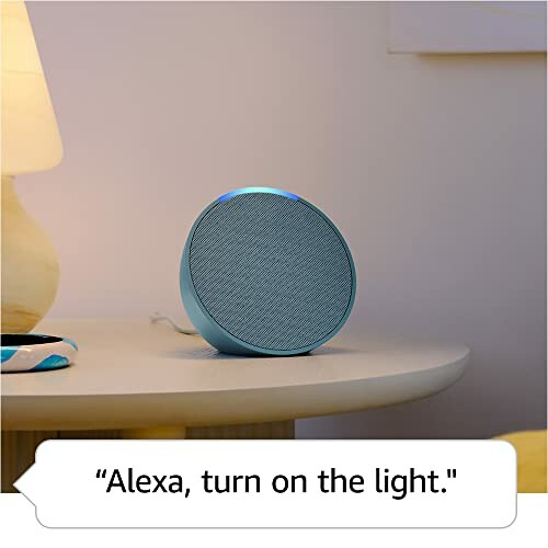 Smart speaker on a table with a voice command bubble saying 'Alexa, turn on the light.'