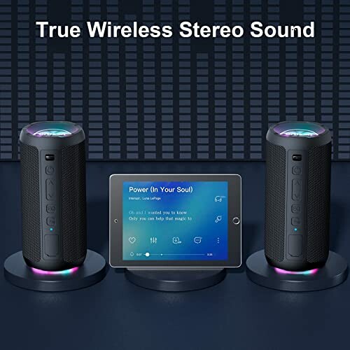 Three wireless stereo speakers with a tablet displaying music